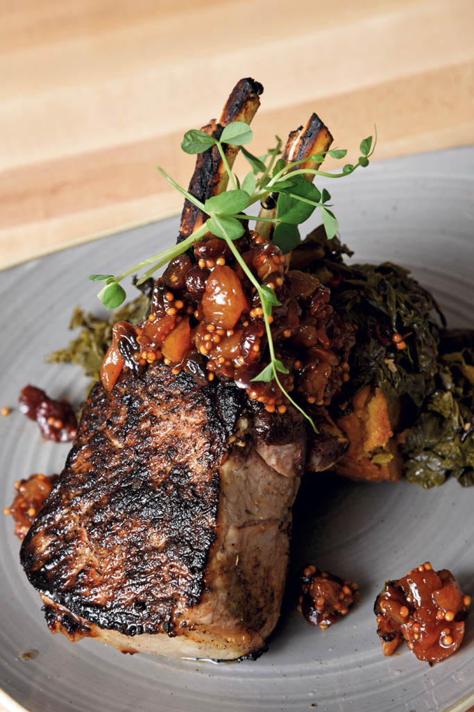 Double-bone pork loin chop with sage cornbread stuffing and braised greens