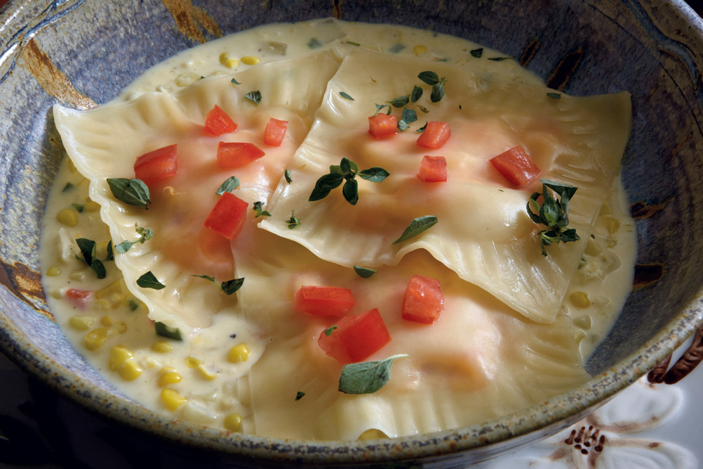 Pimento cheese ravioli over steamed corn