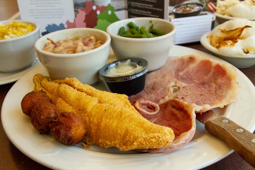 Fried catfish, hushpuppies, country ham, green beans, white beans with ham hock, sweet corn, and banana bread pudding.