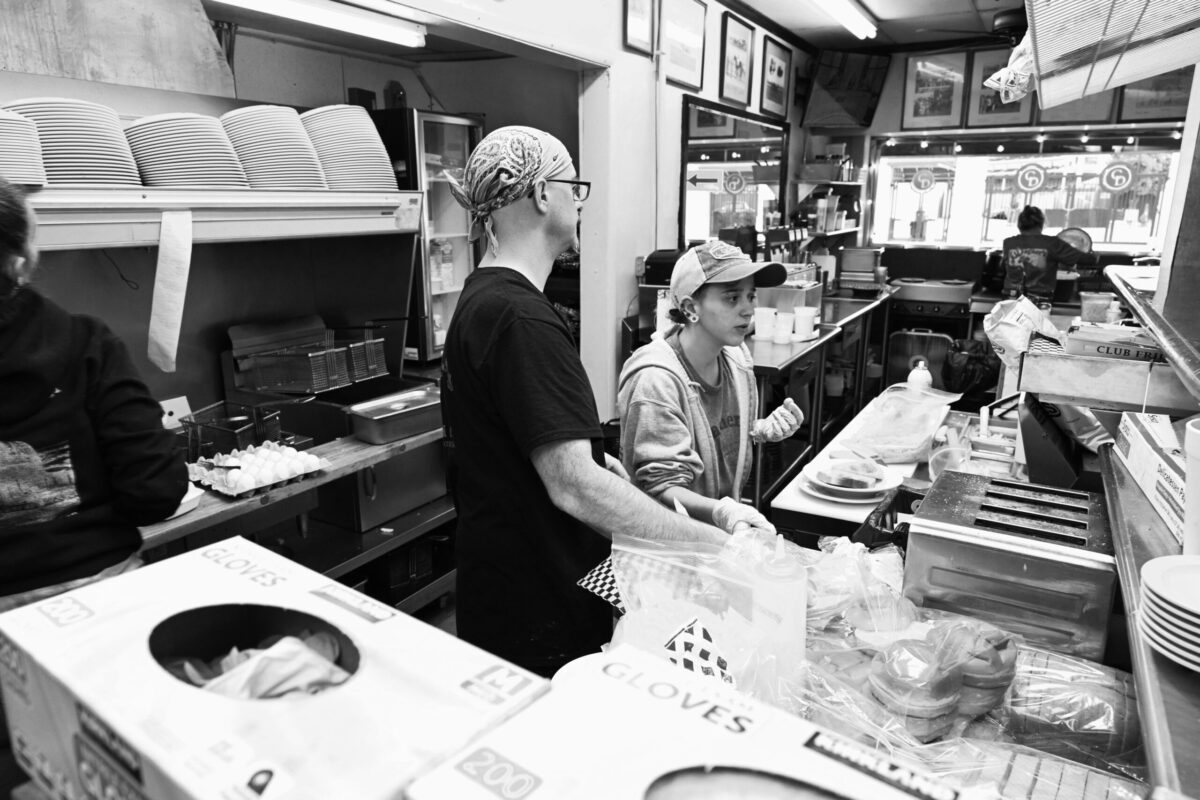 John Herzog and Felocity Kron man Wagner's kitchen.